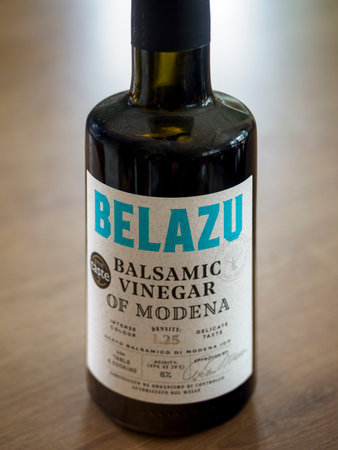 Manchester, UK, September 09, 2024: Bottle of balsamic vinegar from Modena placed on wooden surface.のeditorial素材