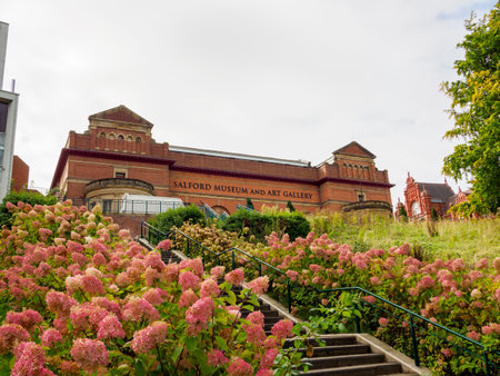 Salford, Manchester, UK. September, 28, 2024: Salford Museum and Art Gallery with blooming flowers and lush greenery.のeditorial素材