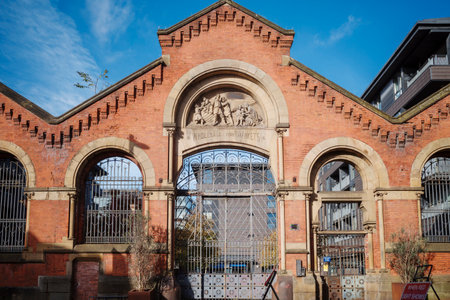 Historic red brick fish market building under a clear blue sky. Manchester city center UK.のeditorial素材