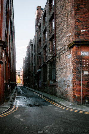 Deserted urban alleyway between old brick buildings. Manchester city center UK.の写真素材