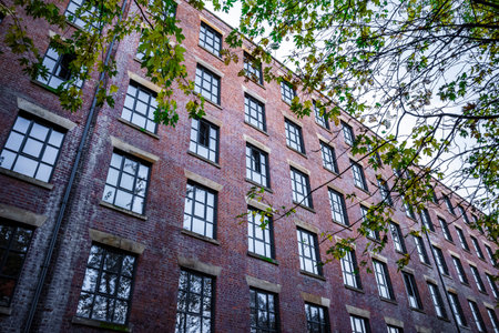 Brick mill building facade converted to apartments in Manchester city center.の写真素材