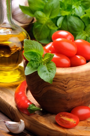 Fresh tomatoes on the wooden cutting boardの写真素材