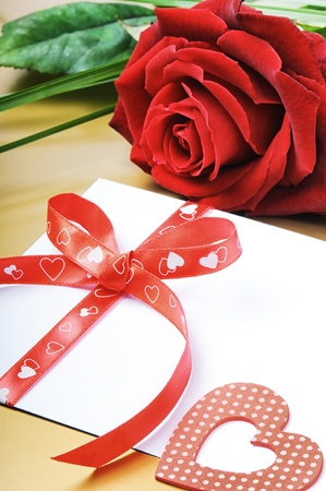 Red rose and envelope in romantic set on golden backgroundの写真素材
