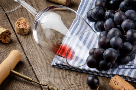 Empty wine glass and grape on wooden tableの写真素材