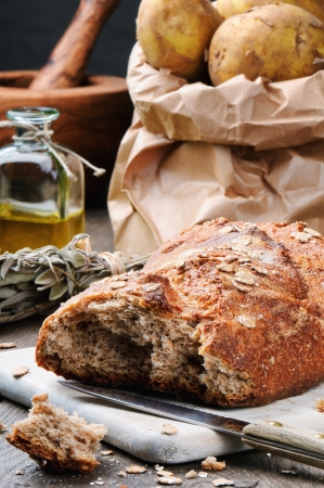 Rustic still-life with fresh bread and potatoの写真素材