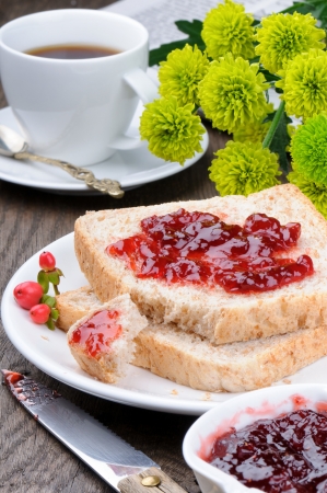 Breakfast with toasts, coffee and summer flowersの写真素材