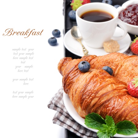 Breakfast with coffee and fresh croissants over whiteの写真素材