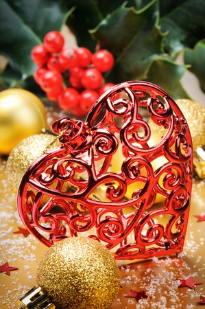 Heart shaped Christmas decoration on golden backgroundの写真素材