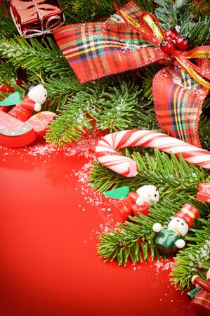 Frame with Christmas tree and vintage decorations on red backgroundの写真素材