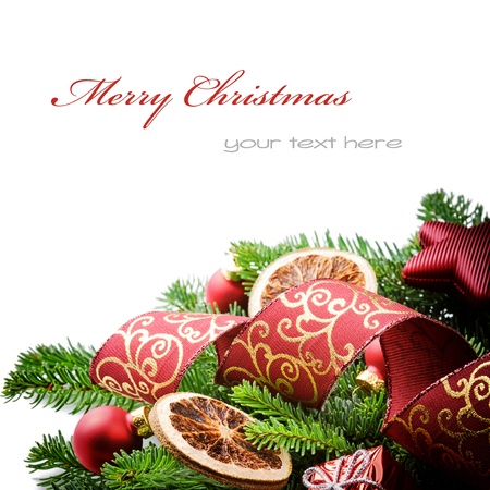 Border with Christmas tree branches and festive decorations isolated over whiteの写真素材