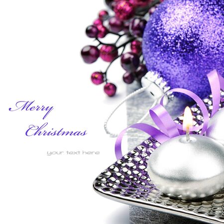 Festive candle and purple Christmas ball isolated over whiteの写真素材