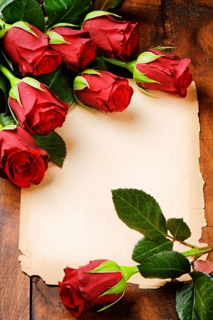 Romantic frame with red roses and vintage paperの写真素材