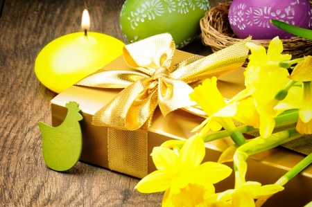 Easter setting with gift box and yellow daffodilsの写真素材