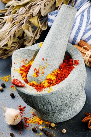 Mortar and pestle with mix of colorful spices on granite backgroundの写真素材
