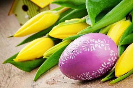Easter setting with yellow tulips and decorative eggの写真素材