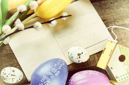 Easter frame with vintage postal card and tulipsの写真素材