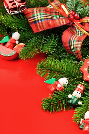 Frame with Christmas tree and vintage decorations on red backgroundの写真素材