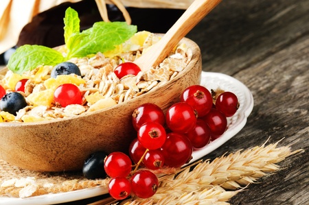 Bowl with cereals and fresh berries on wooden tableの写真素材