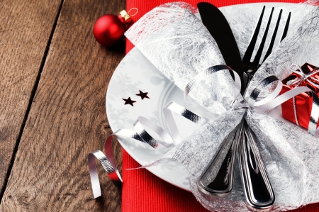 Christmas table setting in red tone on wooden tableの写真素材