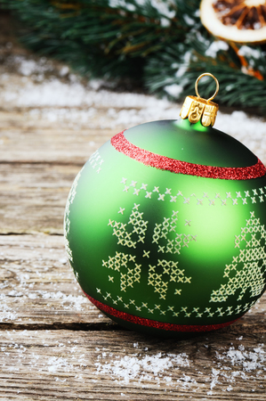Green Christmas ball on wooden backgroundの写真素材