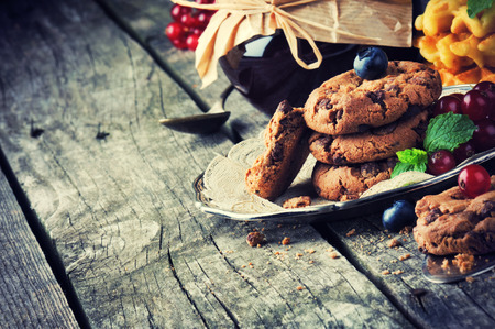 Chocolate chip cookies and jam in vintage settingの写真素材