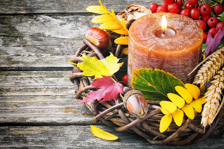 Autumn wreath with candle on wooden backgroundの写真素材