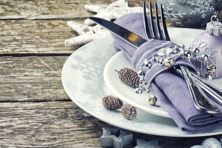 Christmas table setting in silver tone on wooden tableの写真素材