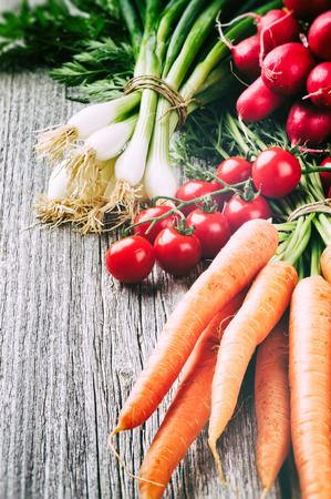 Fresh organic vegetables in rustic settingの写真素材