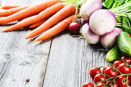 Frame with fresh organic vegetables on wooden backgroundの写真素材
