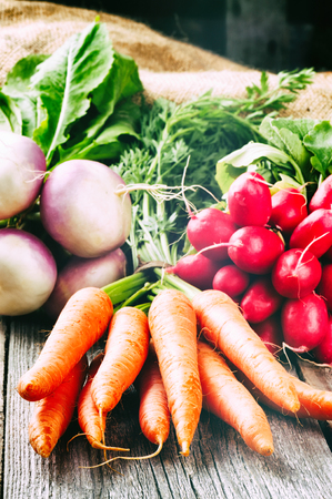 Fresh organic vegetables in rustic settingの写真素材