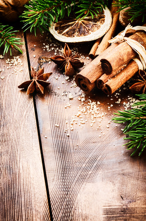 Christmas setting with seasonal spices on wooden backgroundの写真素材