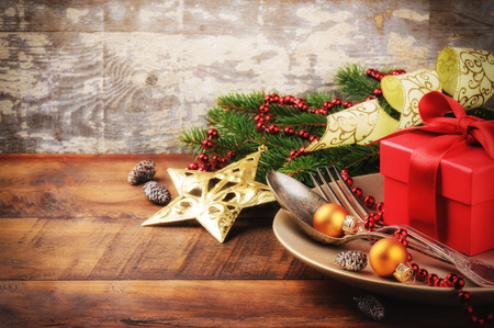 Christmas table setting in gold and red toneの写真素材