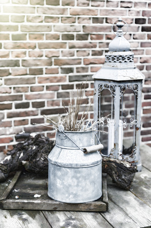 Backyard decoration with vintage milk can and lantern in silver toneの写真素材