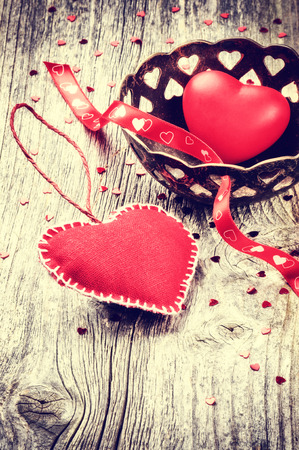 Decorative hearts in retro style on old wood backgroundの写真素材