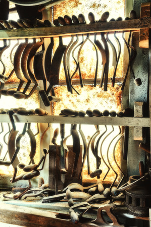 Cooper's workshop with old hand tools hanging on wooden planksの写真素材