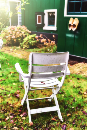 Lonely chair in autumn backyard gardenの写真素材