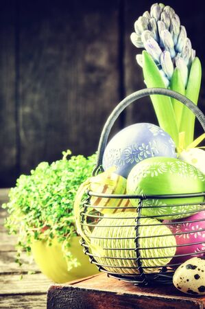 Easter setting with colorful decorative eggs and hyacinthの写真素材