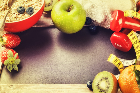 Fitness frame with dumbbells and fresh fruits. Healthy lifestyle concept with copy spaceの写真素材