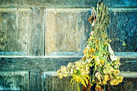 Bouquet of dry wild flowers on wooden background. Copy spaceの写真素材