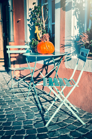 Autumn street decoration with colorful pumpkin on coffee tableの写真素材