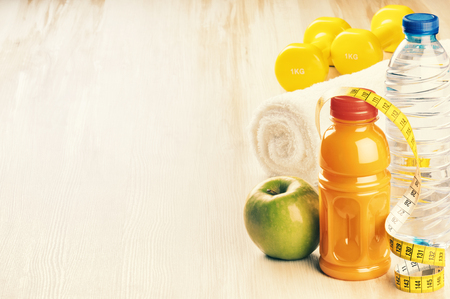 Fitness concept with dumbbells, green apple and water bottle. Copy spaceの写真素材