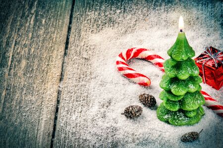 Festive background with Christmas tree candle and candy caneの写真素材