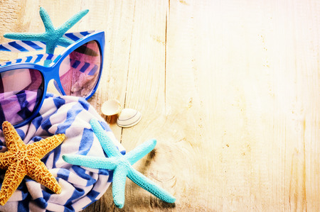 Summer holiday setting with striped scarf, sunglasses and starfishes. Copy spaceの写真素材