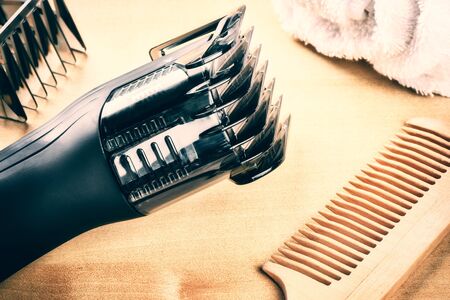 Setting with hair clipper and wooden comb. Closeup shotの写真素材