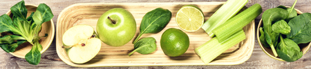 Fresh green vegetables and fruits on wooden background. Detox and diet conceptの写真素材
