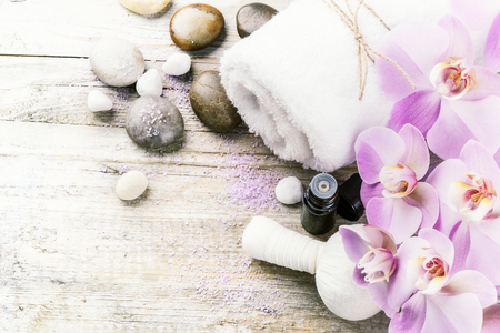 Spa setting with pink orchid, herbal massage ball and essential oil. Wellness conceptの写真素材