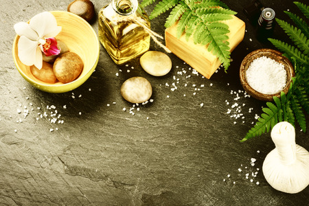 Spa setting with soap bar, herbal massage ball and essential oil. Wellness conceptの写真素材