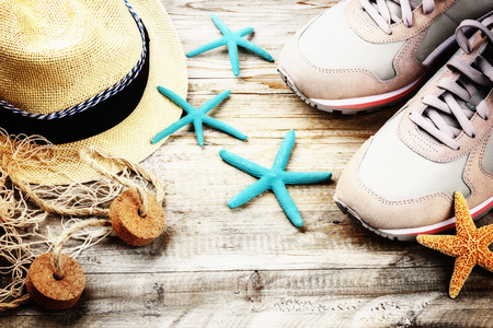 Summer holiday setting with straw hat and seashells. Copy spaceの写真素材