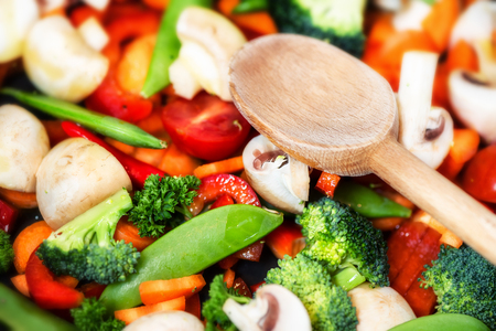 Healthy cooking concept with fresh vegetables and wooden spoon. Food backgroundの写真素材