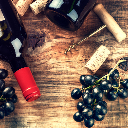 Setting with bottle of red wine, grape and corks. Wine list concept with copy spaceの写真素材